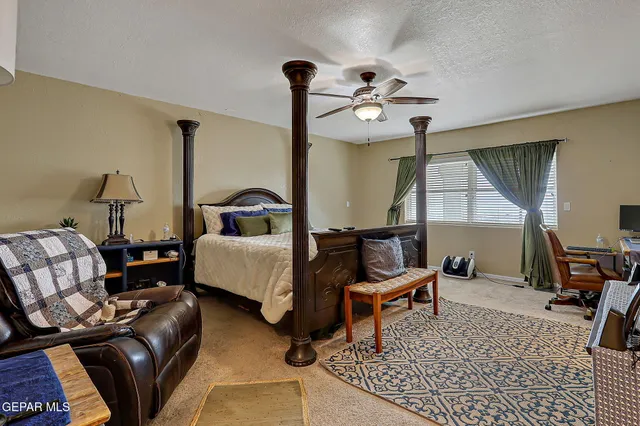 a view of a backyard with chairs and a table