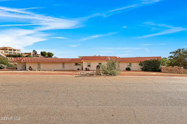 a view of a hallway to a livingroom with furniture and windows
