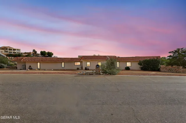 a view of a dining room with furniture a chandelier and window