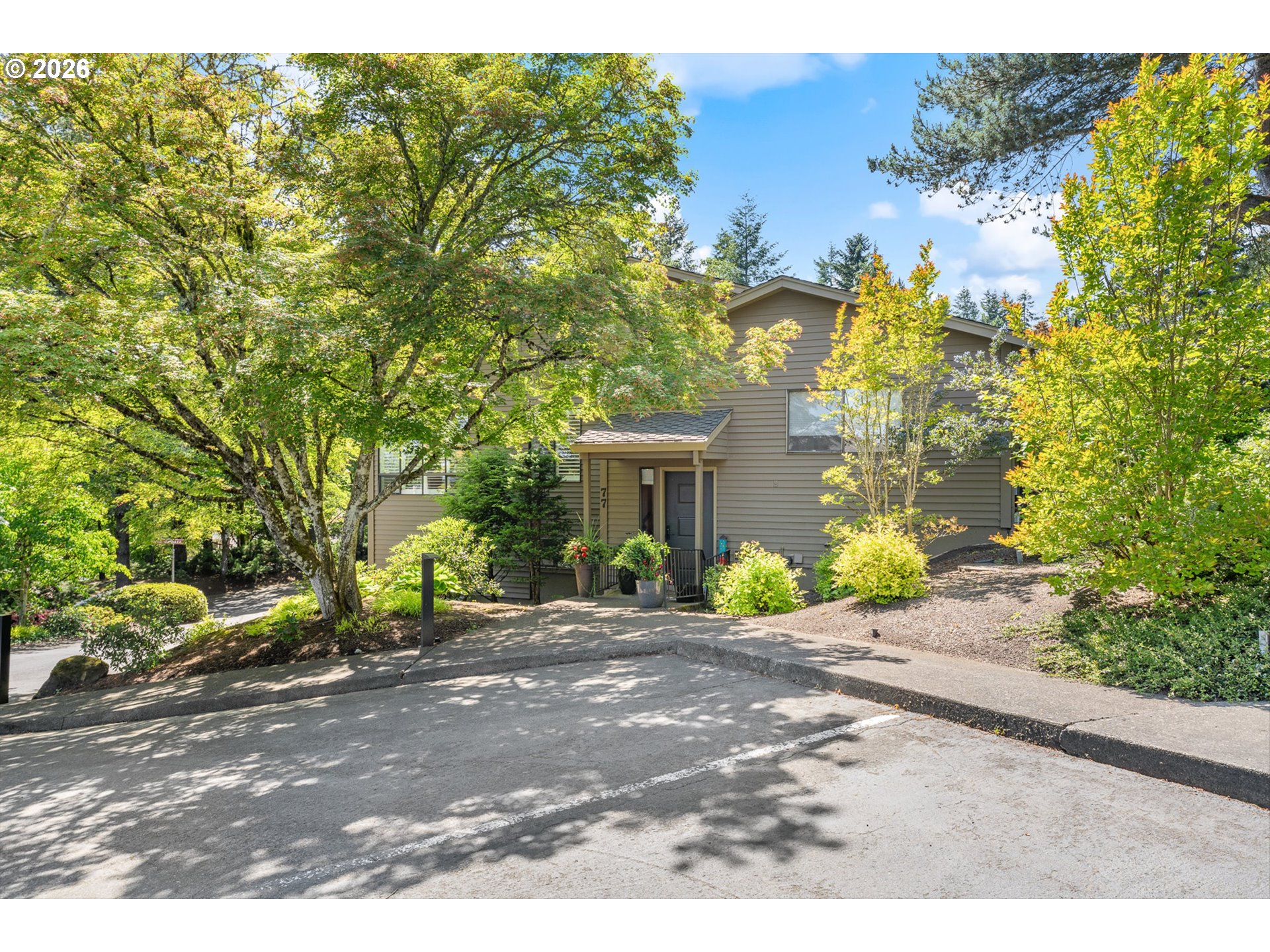 77 Condolea Way Lake Oswego, OR 97035 - Photo 2 of 25 a front view of a house with a yard and garage