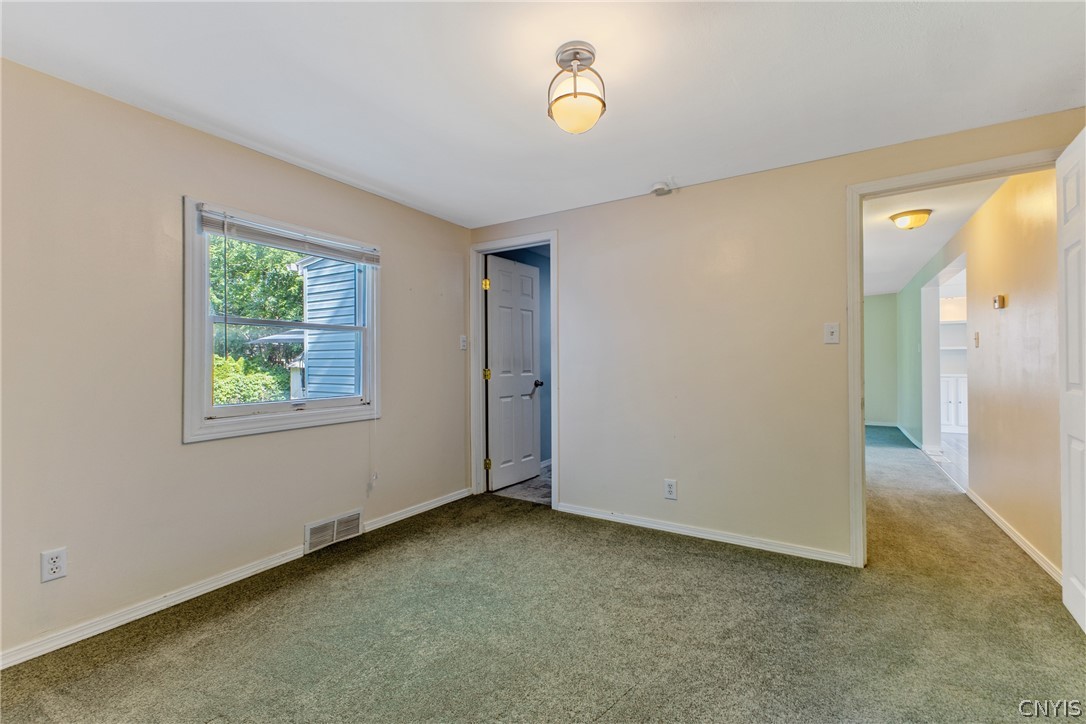 125 Circle Road Salina, NY 13212 - Photo 21 of 39 Primary bedroom with seating area, wood fireplace, double closets, & full bath.