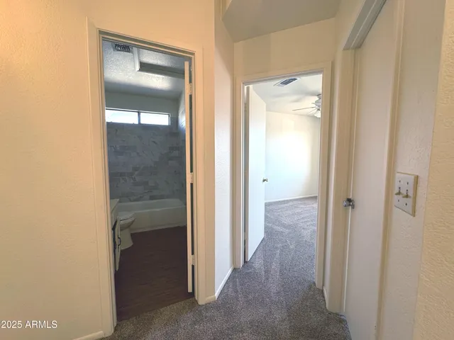 a view of a bathroom from a hallway