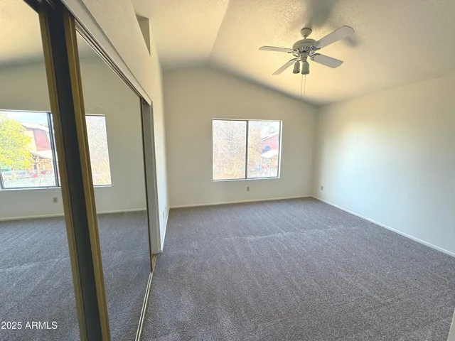 an empty room with windows and entrance