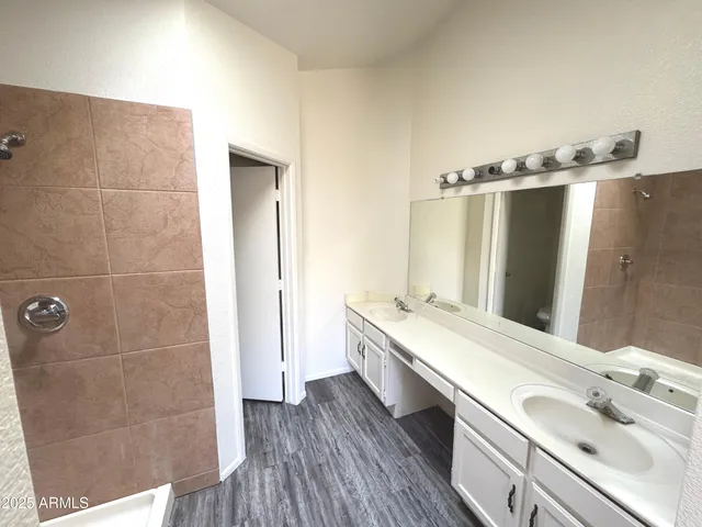 a bathroom with a double vanity sink and mirror
