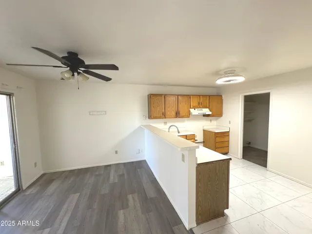 a view of a kitchen with a sink and a window