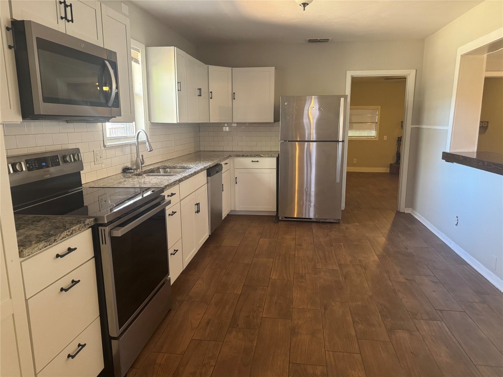 6007 Libyan Drive Austin, TX 78745 - Photo 3 of 8 a kitchen with cabinets stainless steel appliances and a counter space