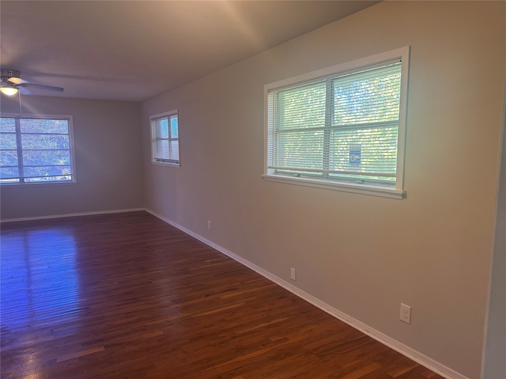 6007 Libyan Drive Austin, TX 78745 - Photo 4 of 8 an empty room with wooden floor and windows