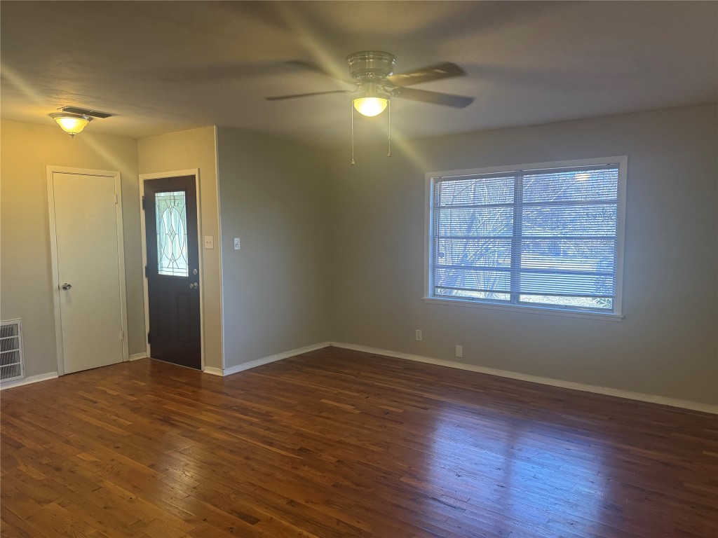 6007 Libyan Drive Austin, TX 78745 - Photo 5 of 8 a view of an empty room with wooden floor and a window