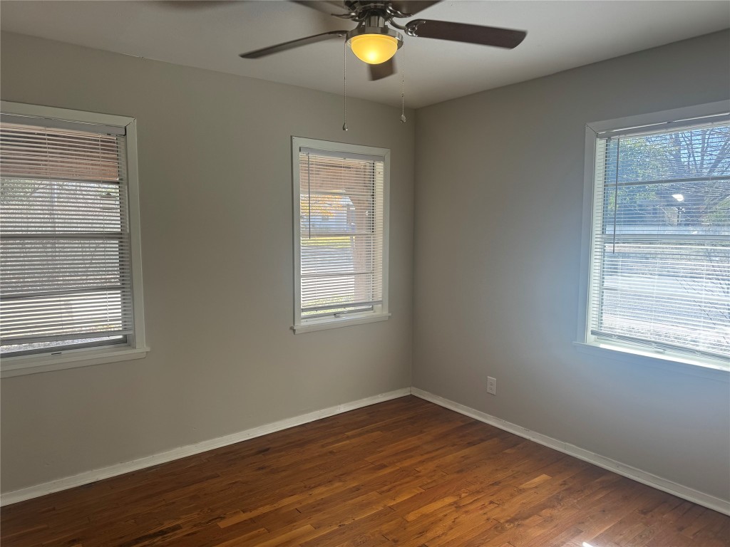 6007 Libyan Drive Austin, TX 78745 - Photo 7 of 8 a view of an empty room with wooden floor and a window