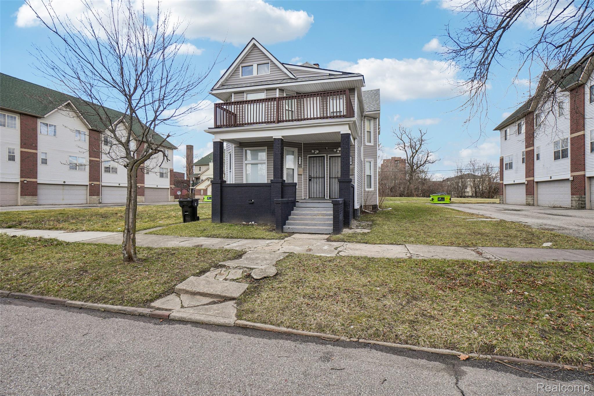 3822 Wabash Street Detroit, MI 48208 - Photo 2 of 17 View of front of house with a front yard, covered porch, and brick siding