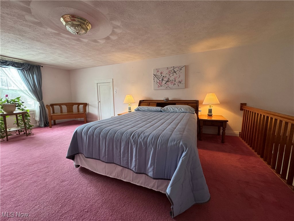 71322 Sharon Road Bridgeport, OH 43912 - Photo 28 of 39 Carpeted bedroom with a textured ceiling and baseboards