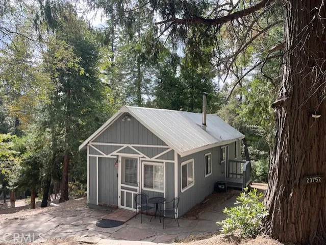 a white house covered with tall trees