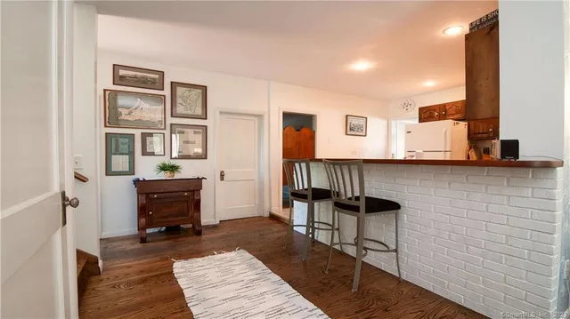 a bedroom with bed and wooden floor