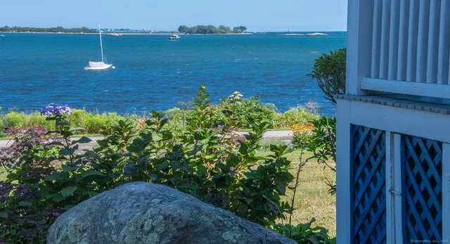 a view of a balcony with chair & floor to ceiling window