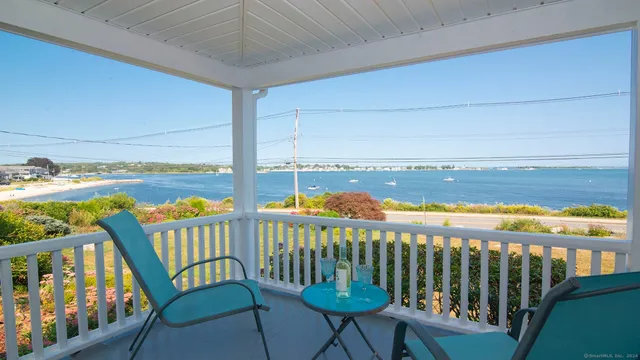 a front view of a house with outdoor seating and plants
