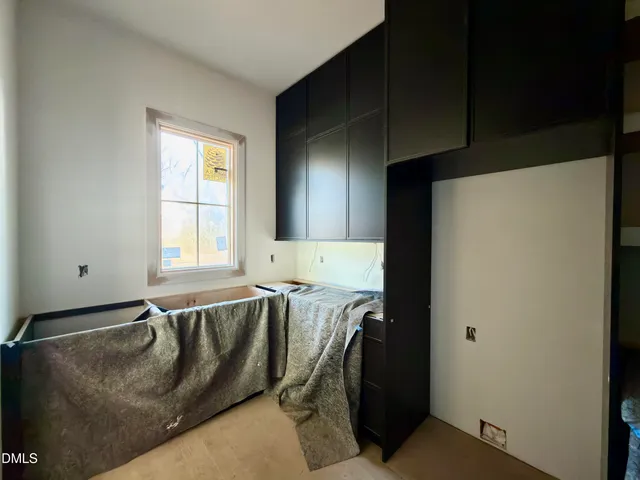 a room with a bed and a large window