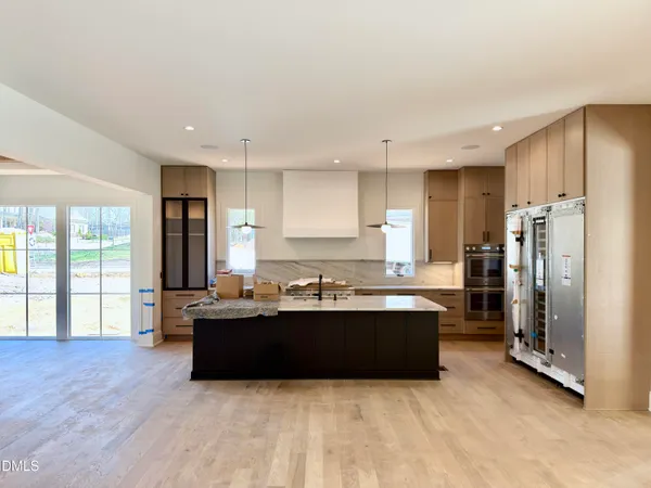 a kitchen with granite countertop a stove and refrigerator