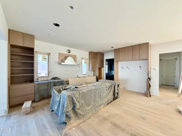 a spacious bedroom with a large bed and a wooden floor