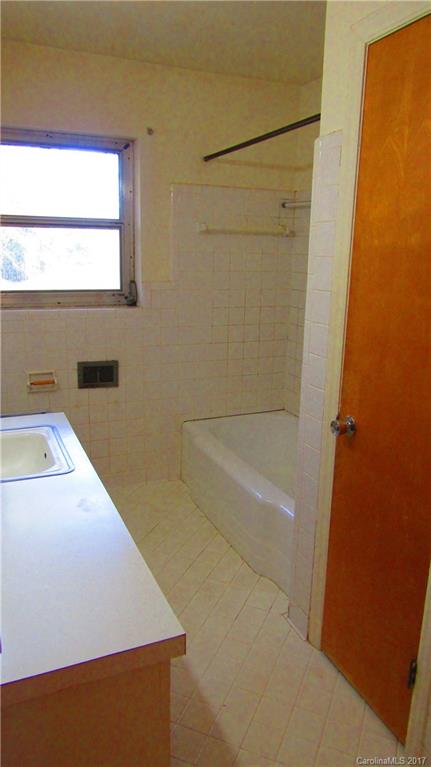 4901 Cheviot Road Charlotte, NC 28269 - Photo 13 of 23 a bathroom with a bathtub and a window