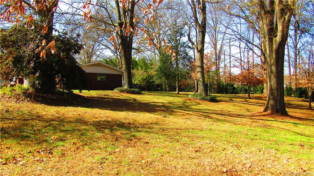 4901 Cheviot Road Charlotte, NC 28269 - Photo 22 of 23 a view of swimming pool with large trees and a big yard