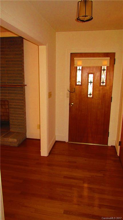 4901 Cheviot Road Charlotte, NC 28269 - Photo 4 of 23 a view of an empty room with wooden floor