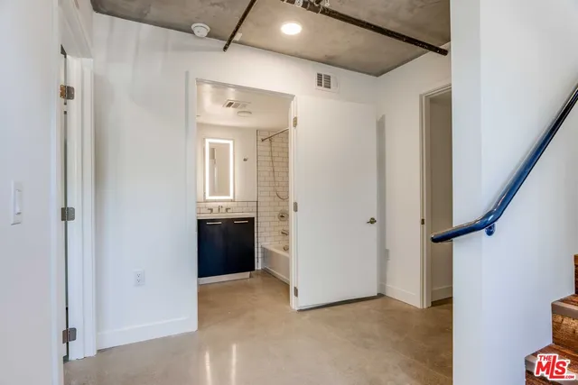 a view of a hallway with wooden shelves