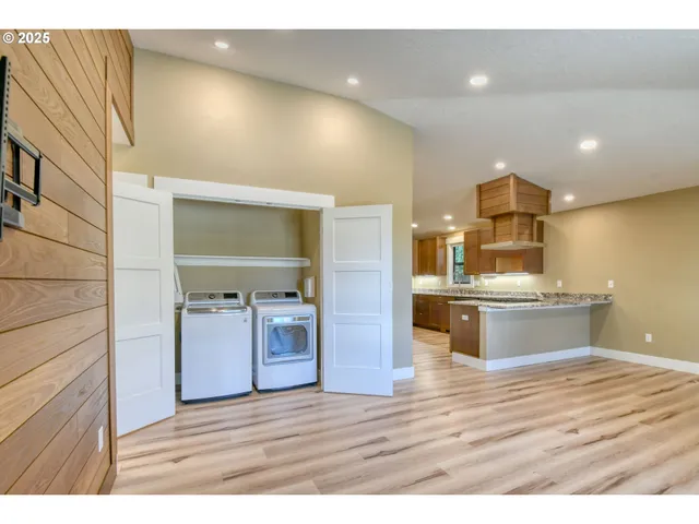 a view of living room and kitchen with wooden floor