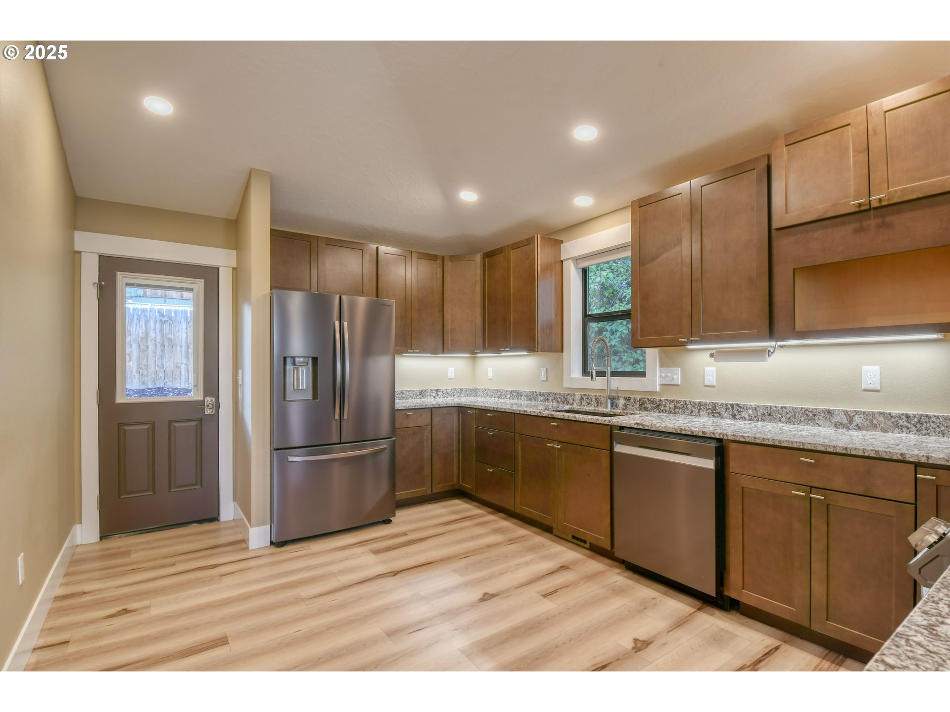 2716 Southwest Hailey Avenue Pendleton, OR 97801 - Photo 10 of 40 a kitchen with granite countertop stainless steel appliances refrigerator sink and cabinets