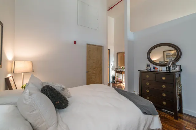 a bedroom with a bed and a dresser