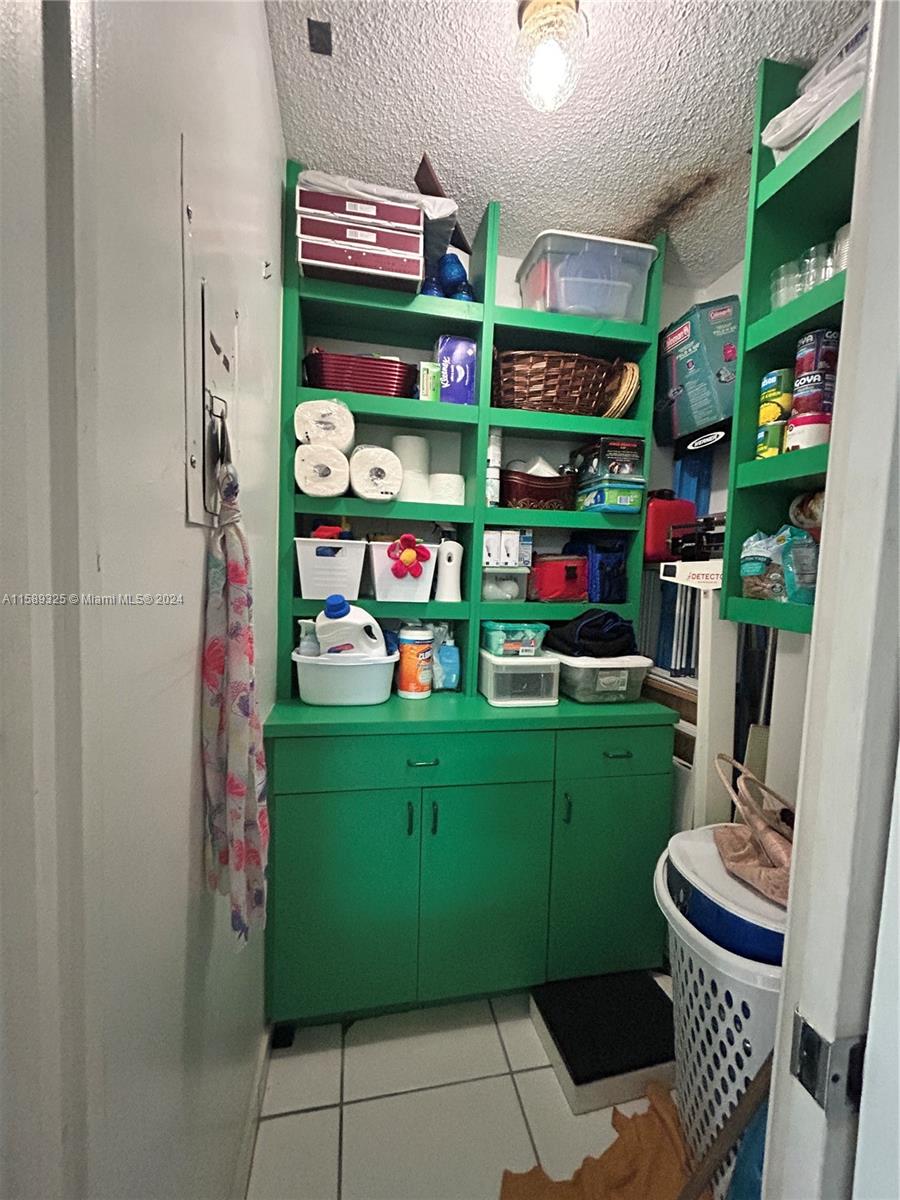 5050 Northwest 7th Street, Unit PH1 Miami, FL 33126 - Photo 15 of 36 a room with cabinets and a wooden floor