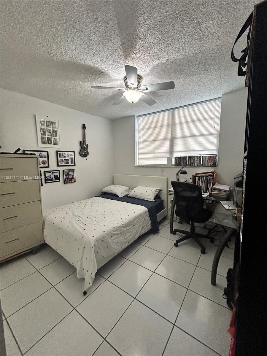 5050 Northwest 7th Street, Unit PH1 Miami, FL 33126 - Photo 20 of 36 a bedroom with a bed furniture and a ceiling fan