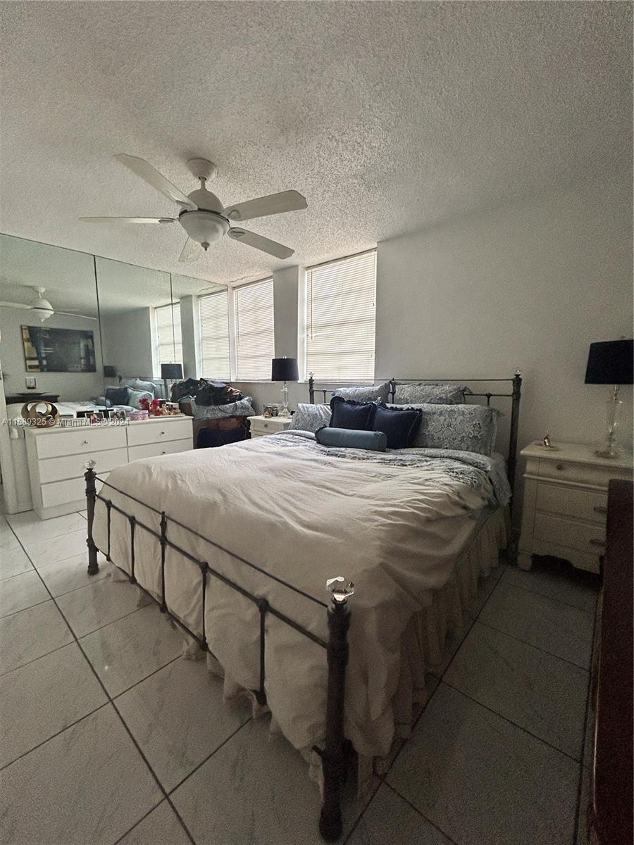 5050 Northwest 7th Street, Unit PH1 Miami, FL 33126 - Photo 27 of 36 a bed room with a bed and a television