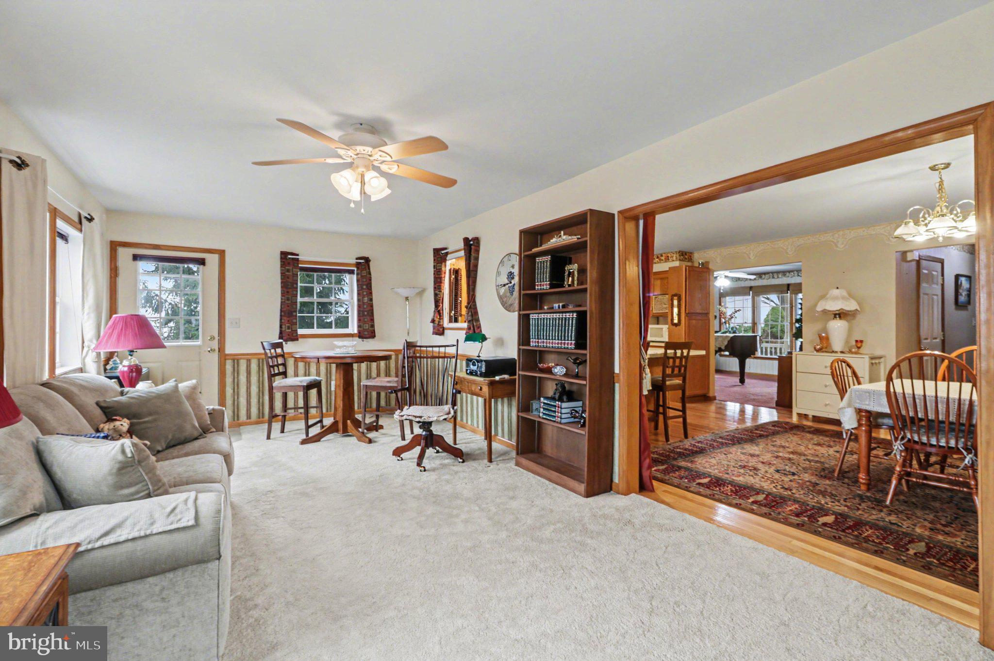467 Beech Tree Street Shippensburg, PA 17257 - Photo 16 of 54 a living room with furniture a chandelier and a flat screen tv
