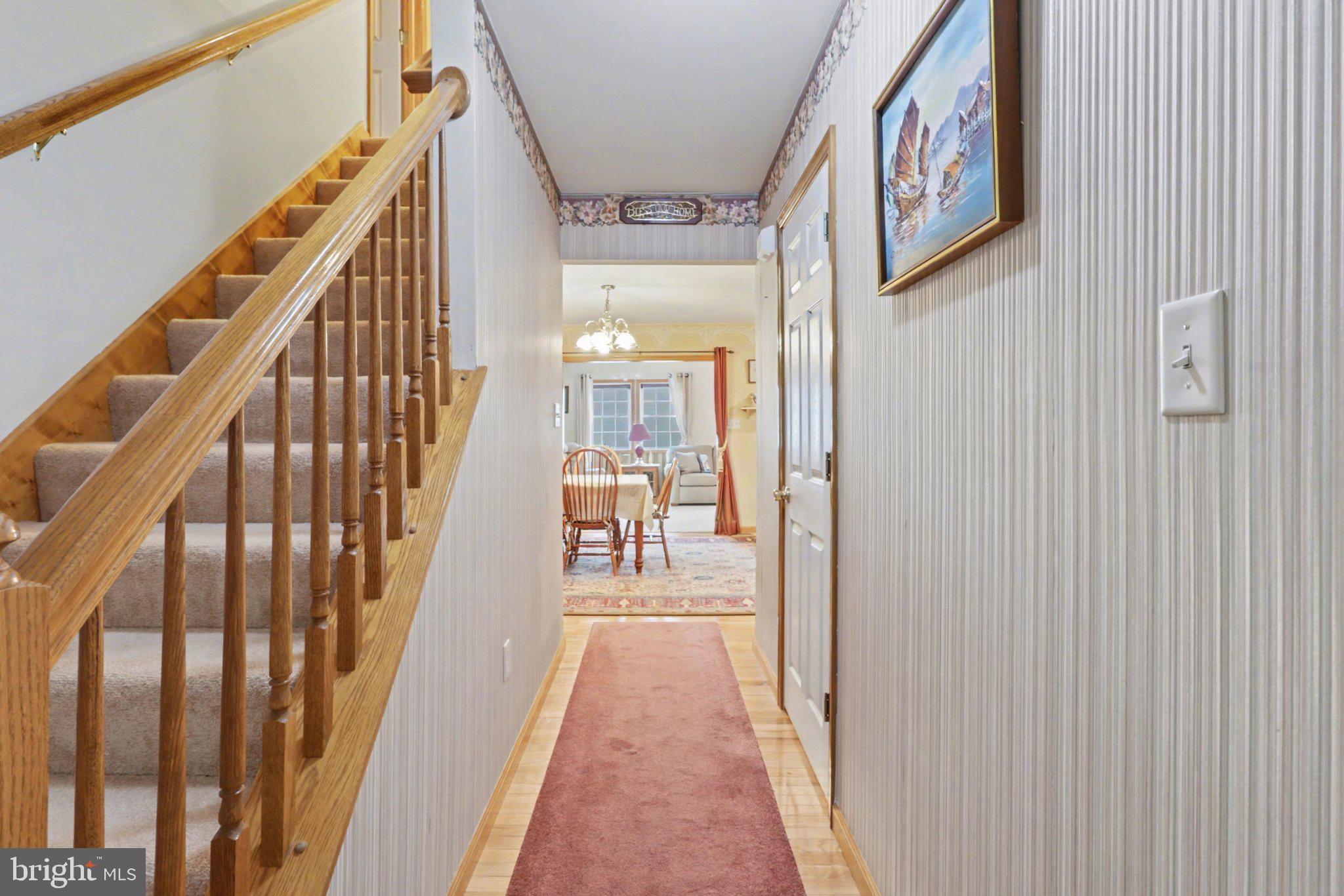 467 Beech Tree Street Shippensburg, PA 17257 - Photo 2 of 54 a view of a hallway with wooden floor and stairs