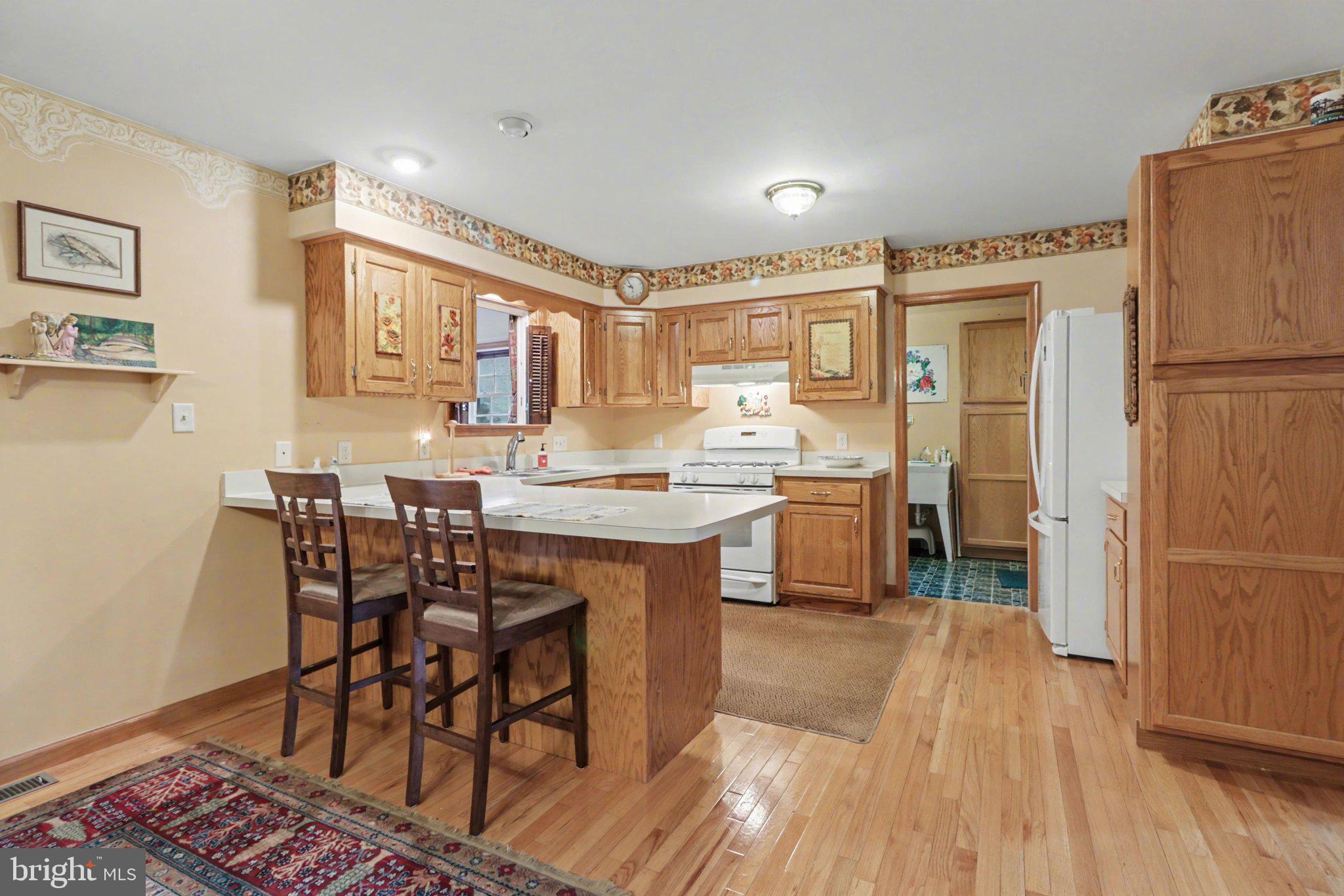 467 Beech Tree Street Shippensburg, PA 17257 - Photo 7 of 54 a kitchen with a table chairs refrigerator and cabinets