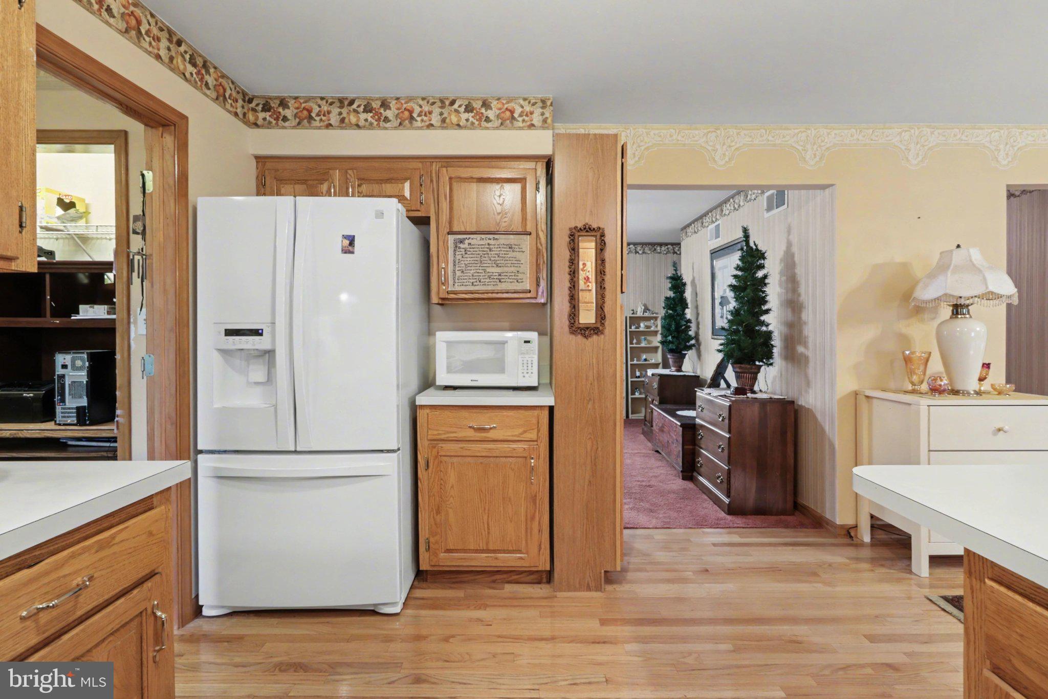 467 Beech Tree Street Shippensburg, PA 17257 - Photo 10 of 54 a kitchen with stainless steel appliances a refrigerator a stove a sink and a dining table with wooden floor