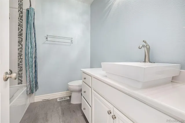 a living room with a fireplace and a wooden floor