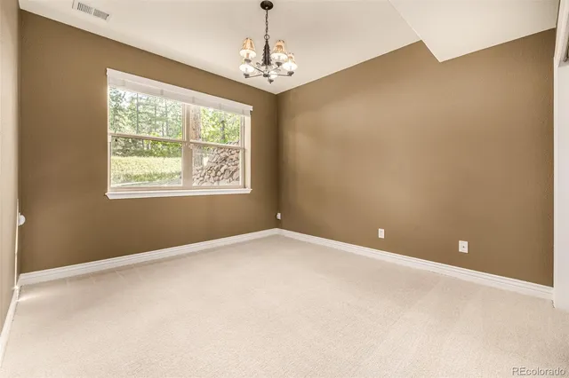 a kitchen with granite countertop white cabinets and a sink