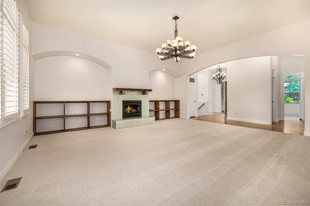 a view of an empty room with a chandelier