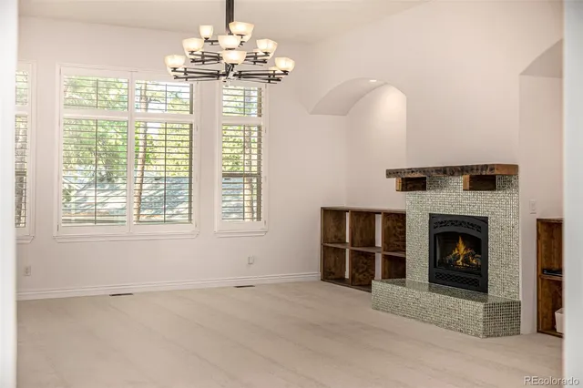 a view of a room with wooden floor and window