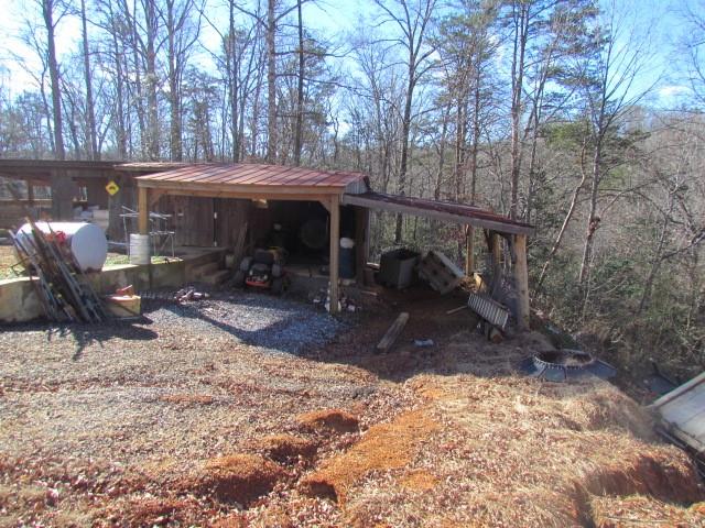 1593 Cheatham Ford Road Hiddenite, NC 28636 - Photo 22 of 36 a view of a patio with a table and chairs