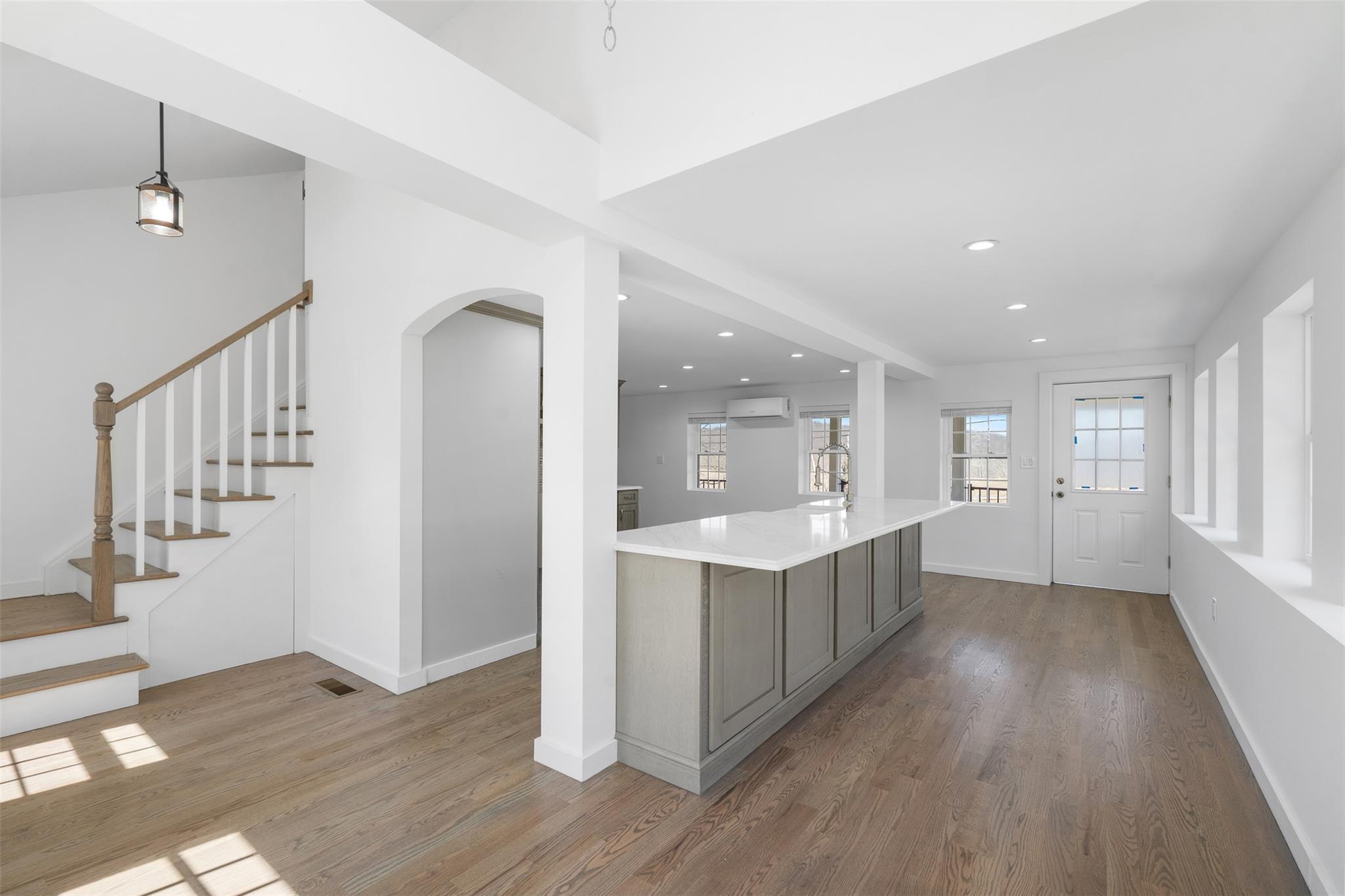 70 Barmore Road LaGrangeville, NY 12540 - Photo 7 of 47 Kitchen featuring an AC wall unit, gray cabinets, wood finished floors, light countertops, and recessed lighting