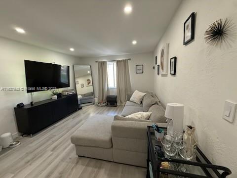 8607 Southwest 68th Court, Unit 27 Pinecrest, FL 33156 - Photo 2 of 9 a living room with furniture and a flat screen tv