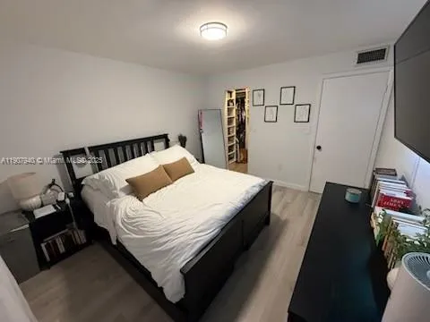 a bed sitting in a bedroom next to a window