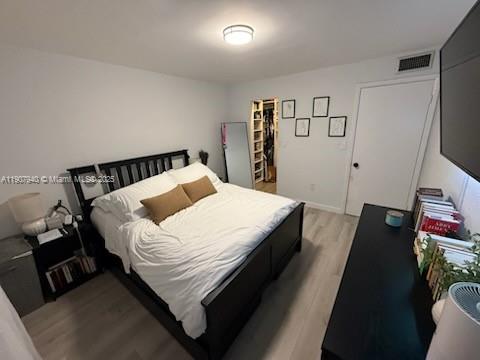 8607 Southwest 68th Court, Unit 27 Pinecrest, FL 33156 - Photo 6 of 9 a bed sitting in a bedroom next to a window