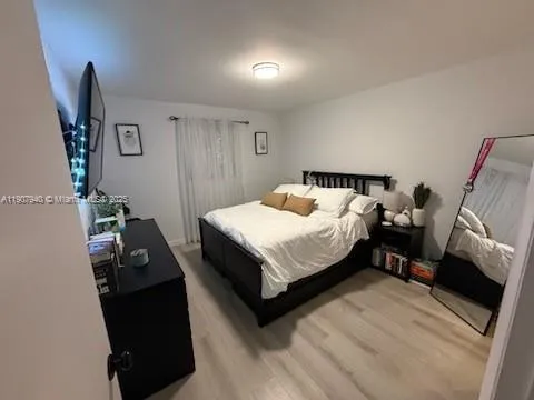 a bed room with a bed and a television