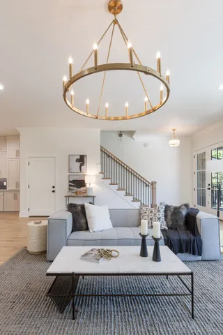 a living room with furniture fireplace and a large window