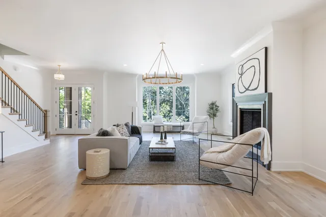 a living room with a balcony a bed and a window