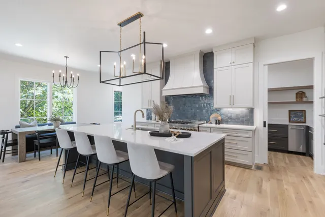 a large kitchen with a table and chairs in it