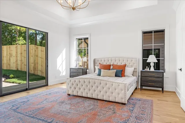 a bedroom with a bed and a chandelier